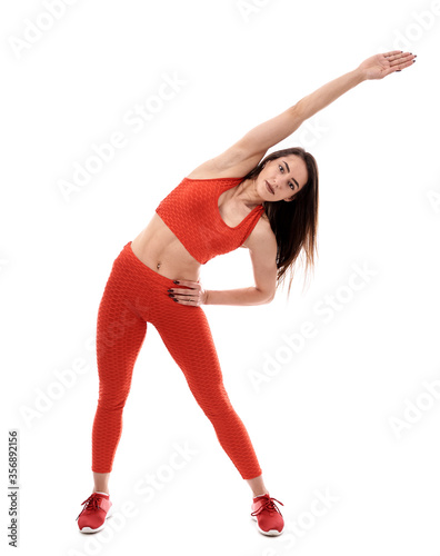 Young female fitness model on white