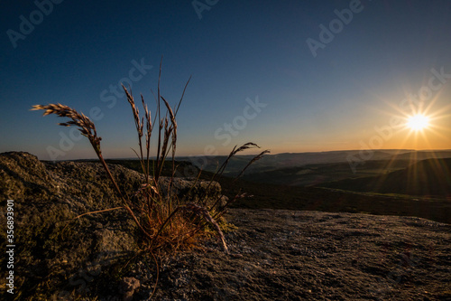 Grass at Higger Tor, in the dramtic Peak Distric, fantastic adventure travel destination or holiday vacation to view picturesque scenery at sunrise or sunset 