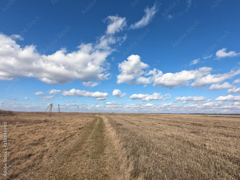 Blue sky with white clouds over farmland. Landscape. Blue sky with white clouds over farmland. Landscape.