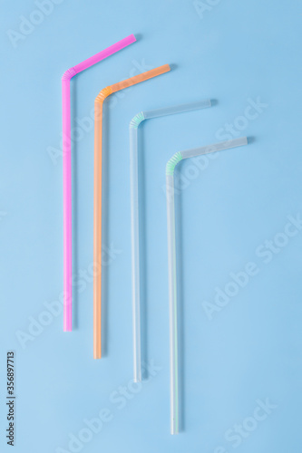  Plastic tube for drinks on a blue background.