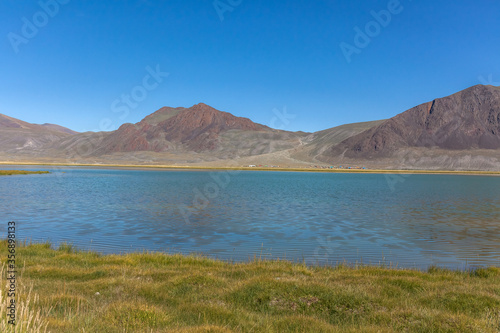 Wild mountain lake in the Altai mountains, summer landscape, Mongolia landscape. Altai Tavan Bogd National Park in Bayar-Ulgii. Scenic valley on the background of the mountains.