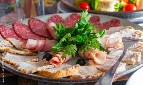 meat and vegetables. assorted sausages of differet types cut into thin plates, close-up