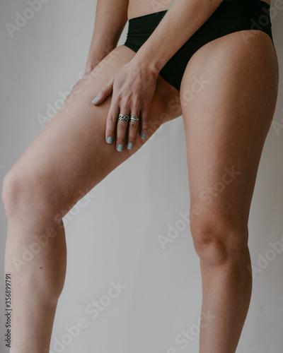 woman hips and hand in black underwear