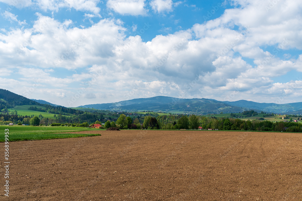rural landscape with hills on the background near Jablunkov town in Czech republic during beautiful springtime day