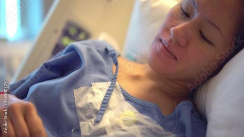 Asian Chinese Mother Patient resting in hospital bed