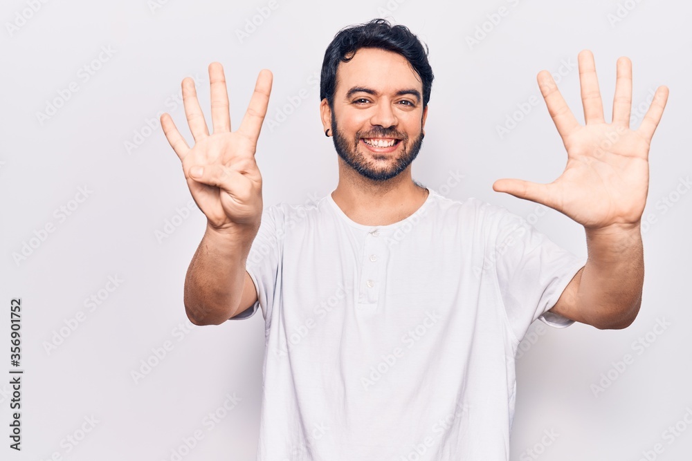 Fototapeta premium Young hispanic man wearing casual clothes showing and pointing up with fingers number nine while smiling confident and happy.