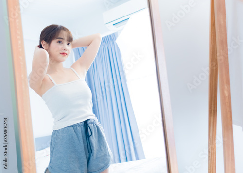 Asian beauty young woman her looking front mirror with clothes fashion