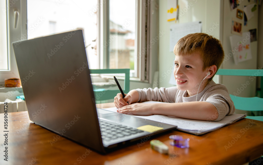 Young boy learning from home, online schooling Young boy learning from home, online schooling