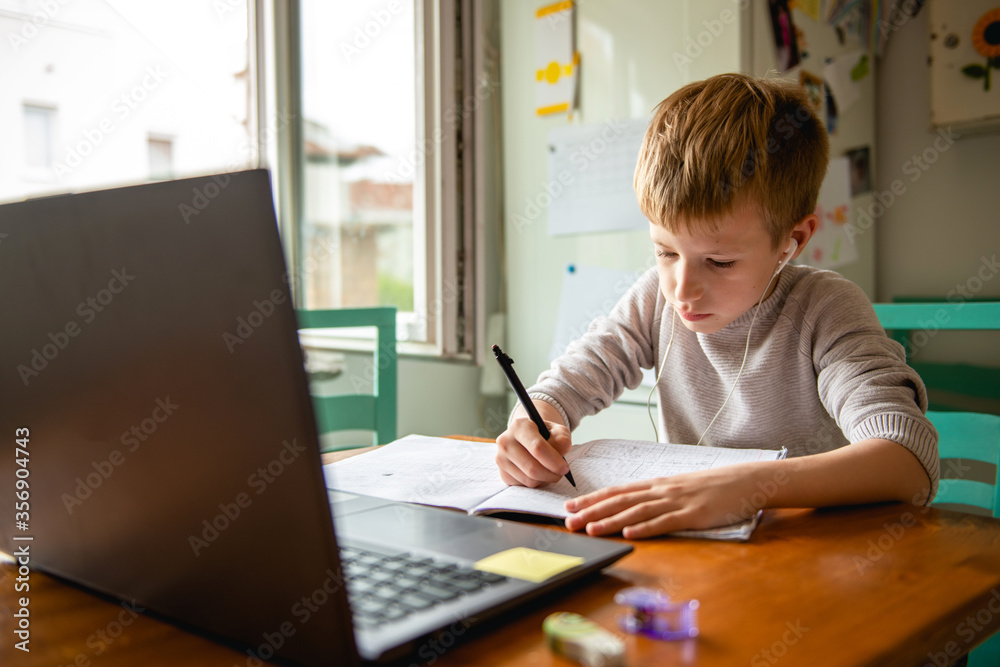 Young boy learning from home, online schooling Young boy learning from home, online schooling