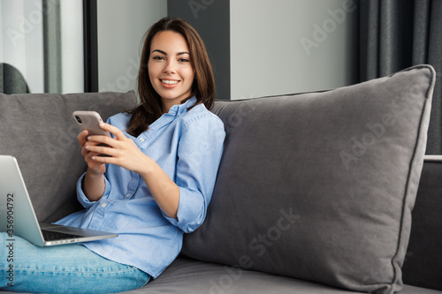 Attractive young woman relaxing on a couch in the living room
