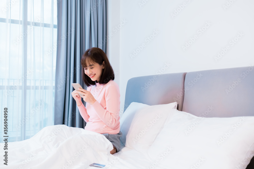 Asian woman checks account on smartphone using credit card online shopping Asian woman checks account on smartphone using credit card online shopping