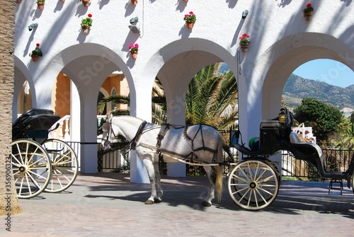 Horse drawn carriages along the Balcony of Europe, Nerja, Andalusia, Spain.