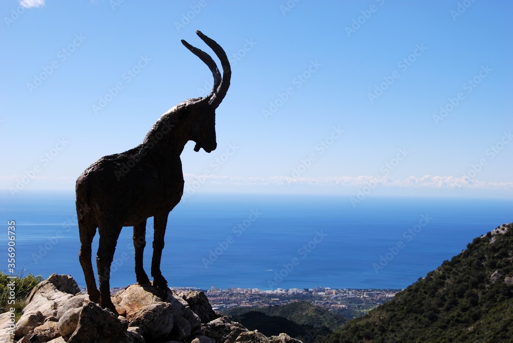 Bronze goat on a hill top at Refugio de Juanar near Marbella, Andalusia, Spain.