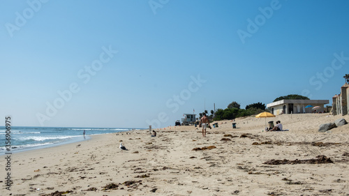 View on Malibu beach in the summer with seaside and people
