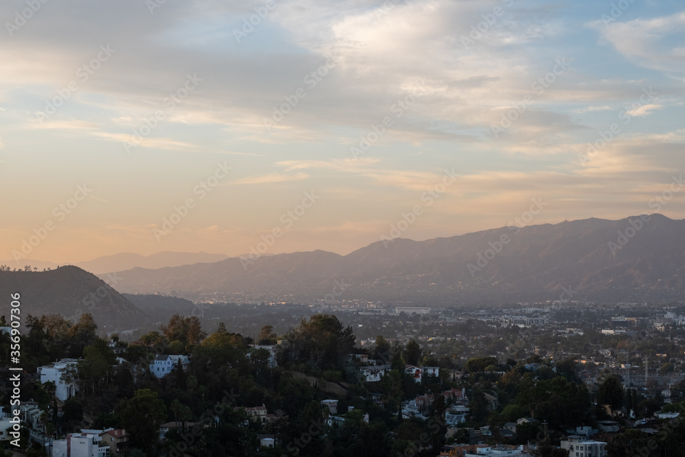 View at sunrise above Los Angeles with a spider lying on its wire 