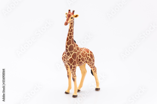 close up of a giraffe from a plastic toy isolated on a white background