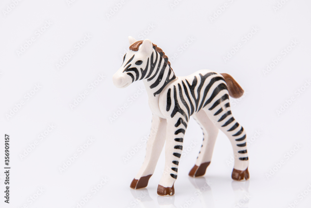 Fototapeta premium close up of a plastic stripped zebra isolated on a white background