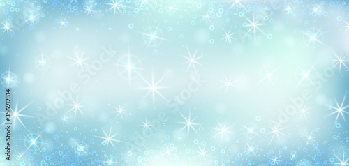 Blue bokeh background. Christmas glowing lights with sparkles. Holiday decorative effect. © ederella