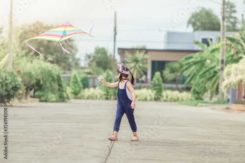 Close-up view of cute girl playing with sports (kite sport), learning outside the classroom during the summer semester and making good use of leisure time. © bangprik