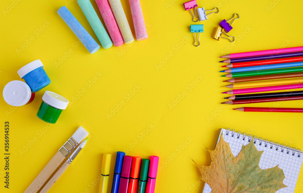 Fototapeta premium back to school. colorful stationery on yellow background