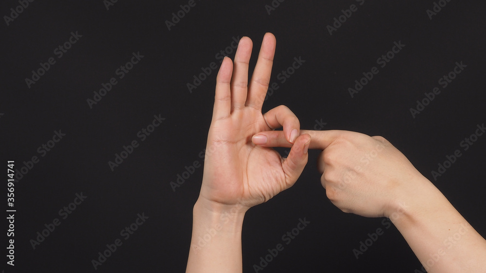 the sex hand sign on black background.