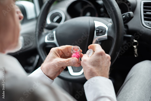 Man taking pills before driving