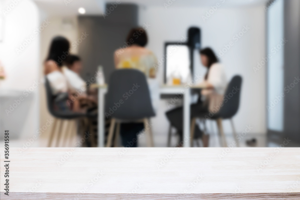 Empty wooden platform with restaurant background for product display montage. Empty wooden platform with restaurant background for product display montage.