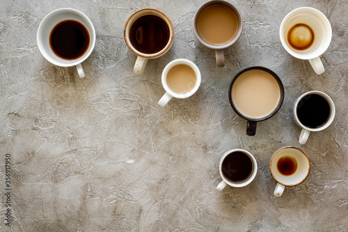 Cups of hot drinks on beige table top-down space for text