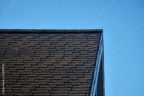 Roof of the house. Trumpet. Wood and roof tiles. Architecture. Texture. Buildings and structures. High quality photo