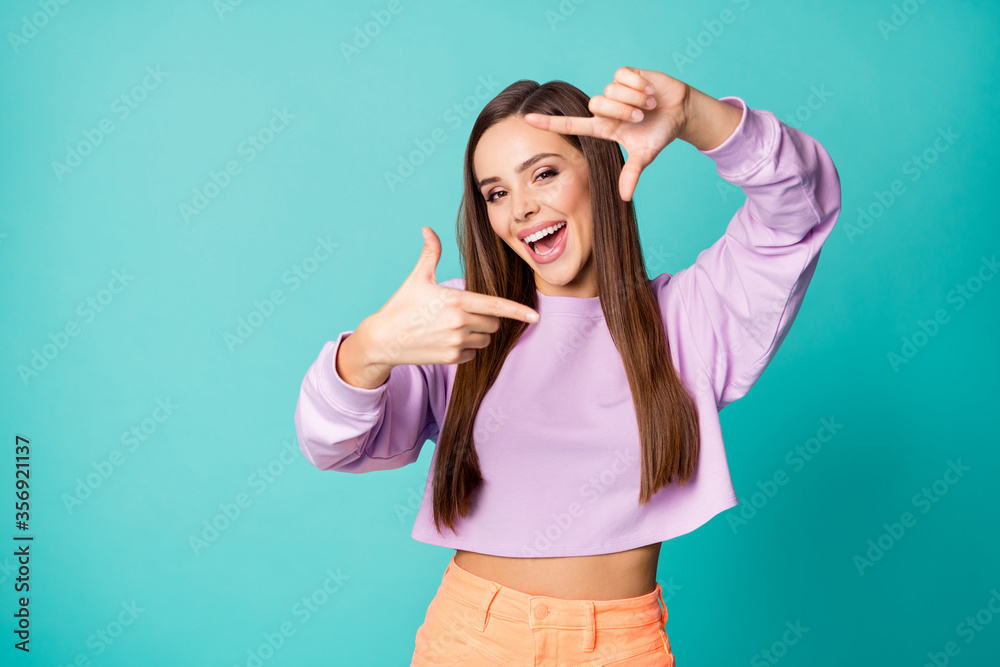 Photo of cool creative imagination lady hold hands making finger frame cadre excited photographer wear cropped pullover orange skirt isolated teal color background