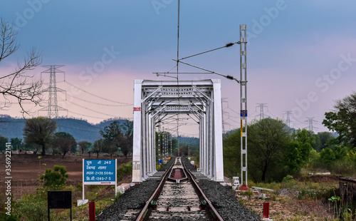 railroad tracks in the middle of the horizon of bridge