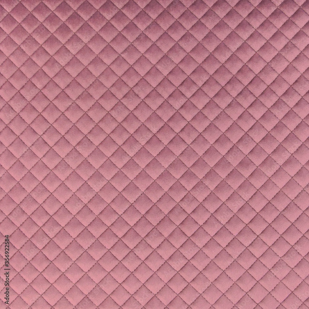 Velvet upholstery quilted fabric texture in mauve Velvet upholstery quilted fabric texture in mauve