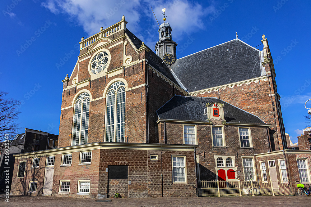 View of Northern church (Noorderkerk) - XVII century Protestant church in Amsterdam. Noorderkerk is located along Prinsengracht canal, on the Noordermarkt square. Amsterdam, Netherlands.