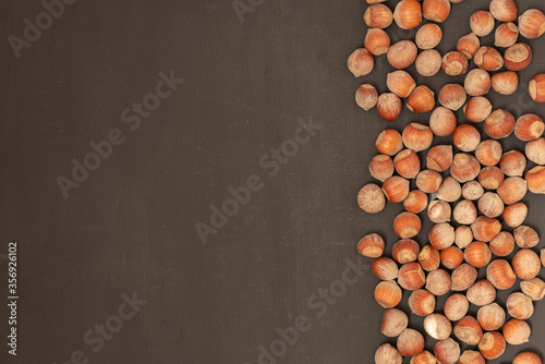 hazelnuts on a black background. top view on the right side