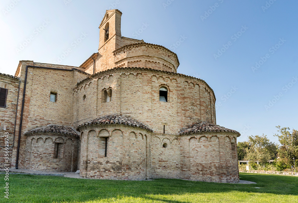 Carolingian church,view of the apse externally, green lawn in the foreground, blue sky
