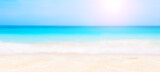 Panorama of summer beach and blurred blue sky.