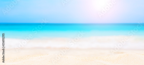 Panorama of summer beach and blurred blue sky. © preto_perola