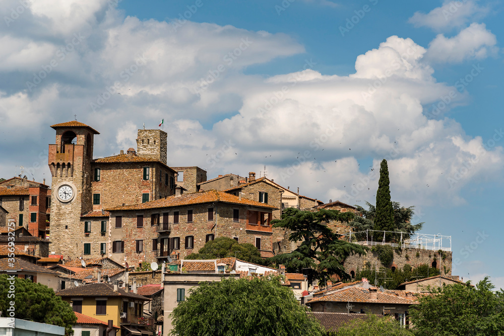 
View of an ancient ancient italian with towers and bell tower, blue sky and clouds background
