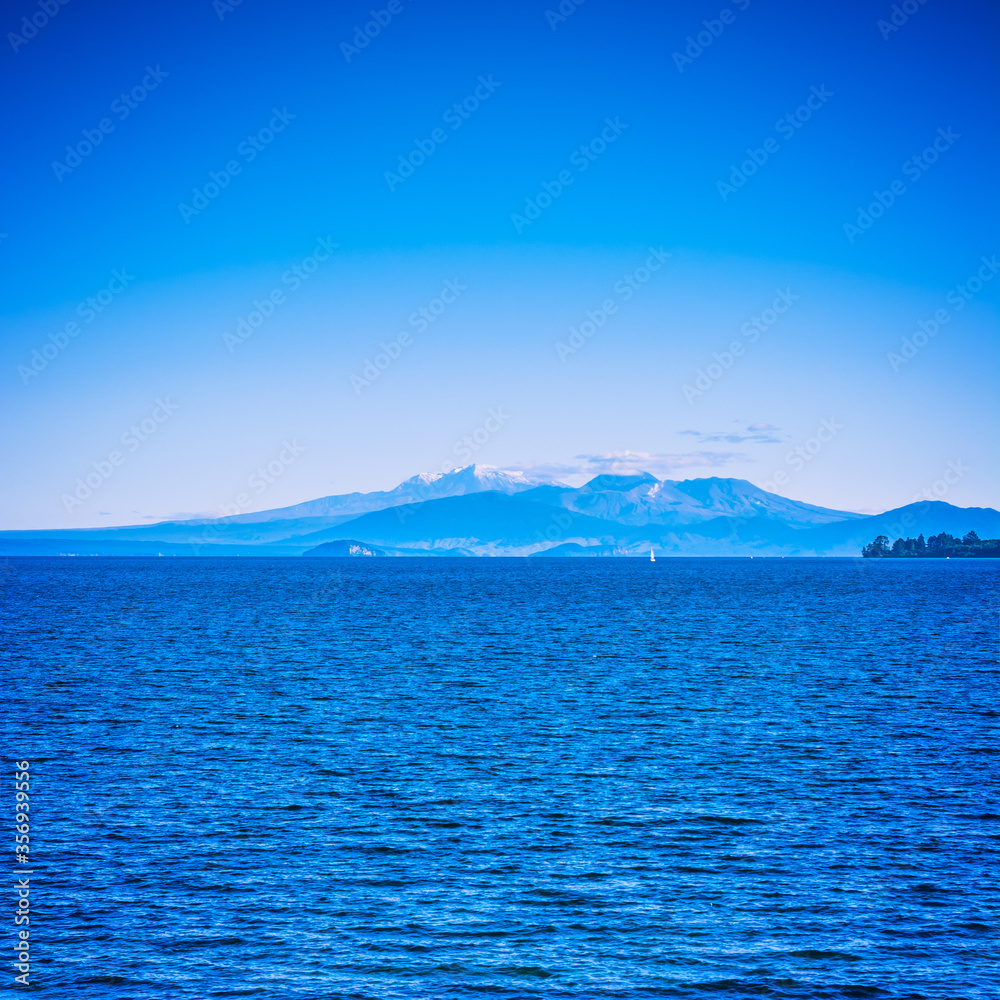 Volcanic cones of Ruapehu towering over great lake of Taupo on a beautiful sunny day. Natural background. North Island Volcanic Plateau, New Zealand
