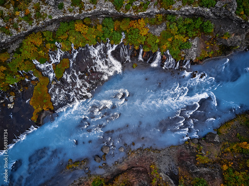 Incredibly beautiful Hraunfossar Waterfall. Lava waterfalls. waterfall flowing down from the lava fields on the canyon of the hvita river, Iceland. Iceland's clean water photo