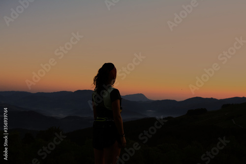 silhouette of a woman standing on the mountain © Egoitzainhoa