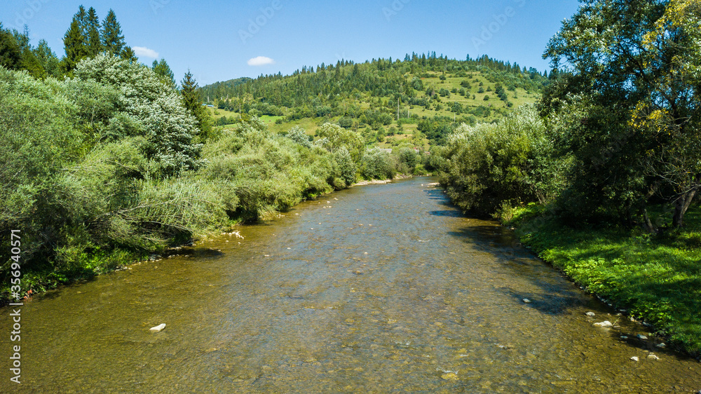 Green mountains of the Carpathians, mountain river