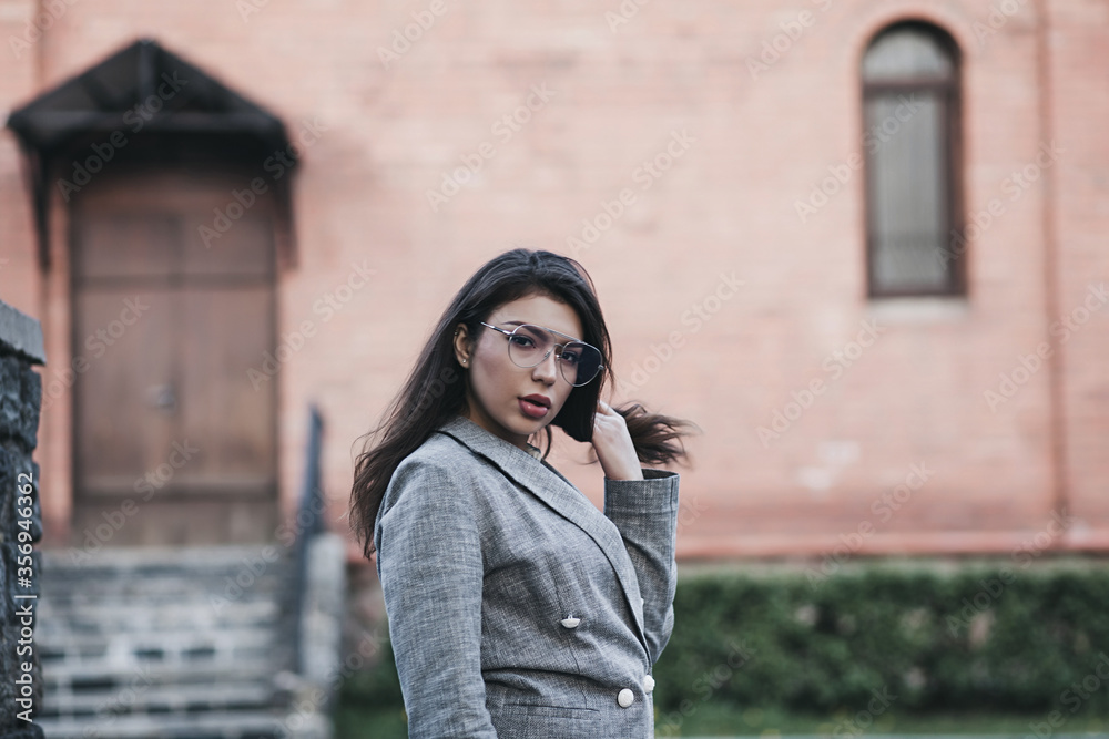 Fototapeta premium Hipster girl in glasses in city street