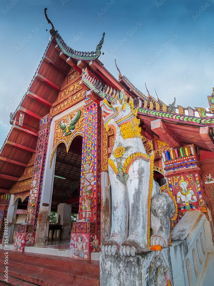 Fototapeta premium view of Singha guardian sculpture in front of buddhist temple, the mythical creatures animal, Wat Wiang Sa, Nan Province, northern of Thailand.