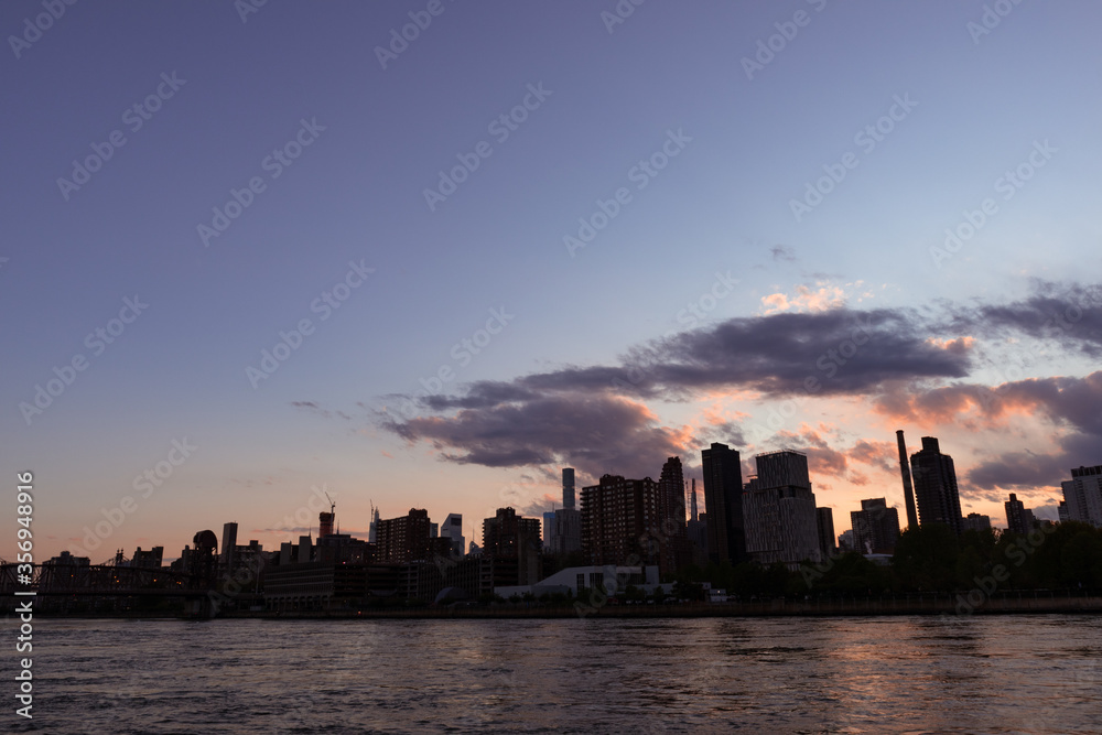 Manhattan and Roosevelt Island Skyline Silhouette during Sunset in New York City along the East River