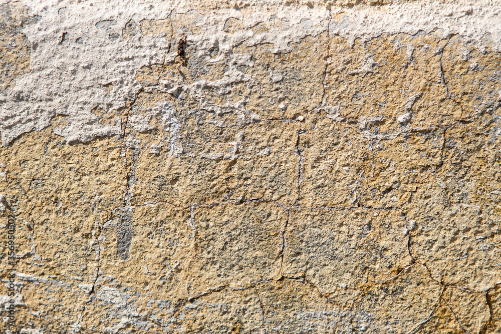 background and texture of old concrete wall with cracked paint on it background and texture of old concrete wall with cracked paint on it