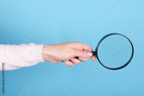 Magnifying glass in hand.