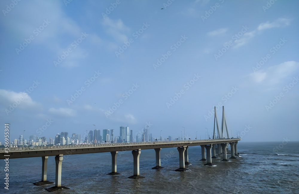 Bandra worli sea-link bridge in sea at Bandra, Mumbai with Mumbai's skyline behind it.