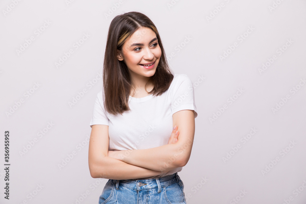 Attractive young woman in casual clothes with arms crossed isolated on white background Attractive young woman in casual clothes with arms crossed isolated on white background