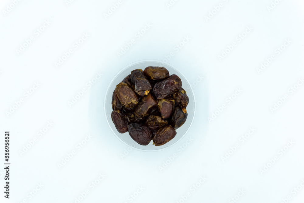 Dates in plastic container over white background Dates in plastic container over white background